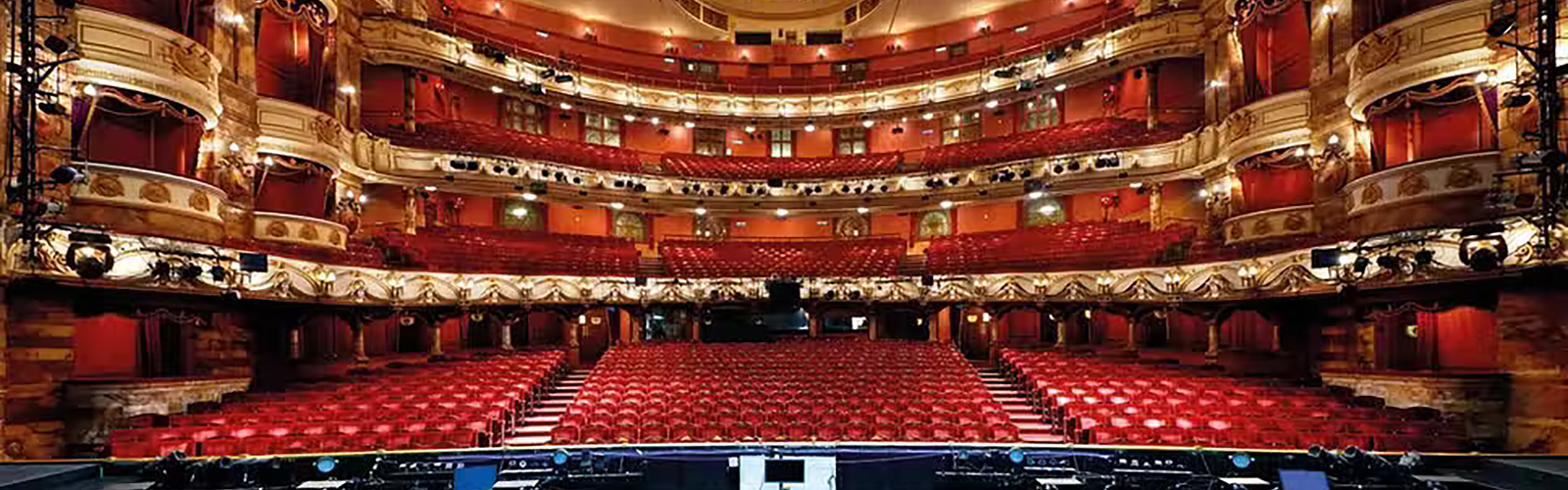 Interior of one of London's iconic theatre's, with a view from the stage. There are many balconies and viewing areas for the audience.